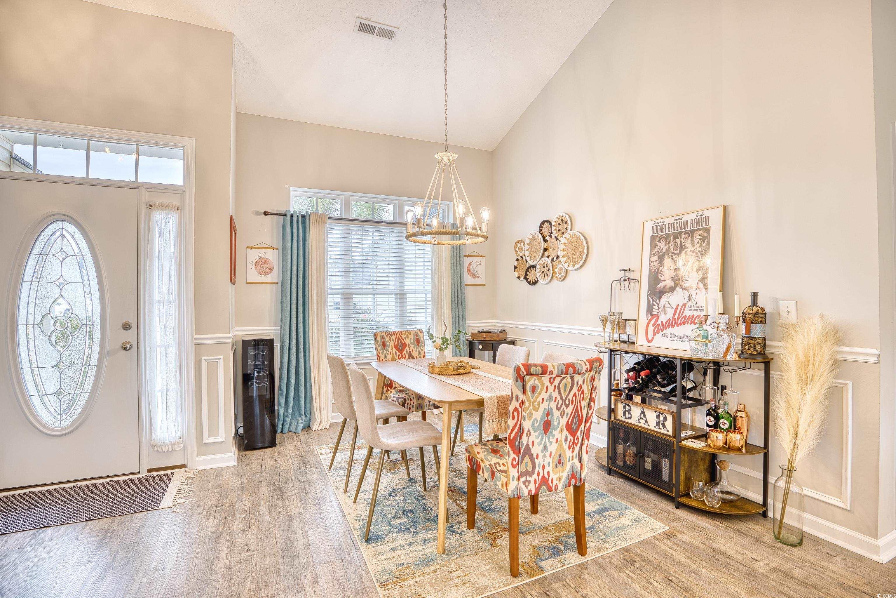 520 Hobie Cat Road Myrtle Beach, SC 29588 - Photo 16 of 40 Dining room with high vaulted ceiling, hardwood /