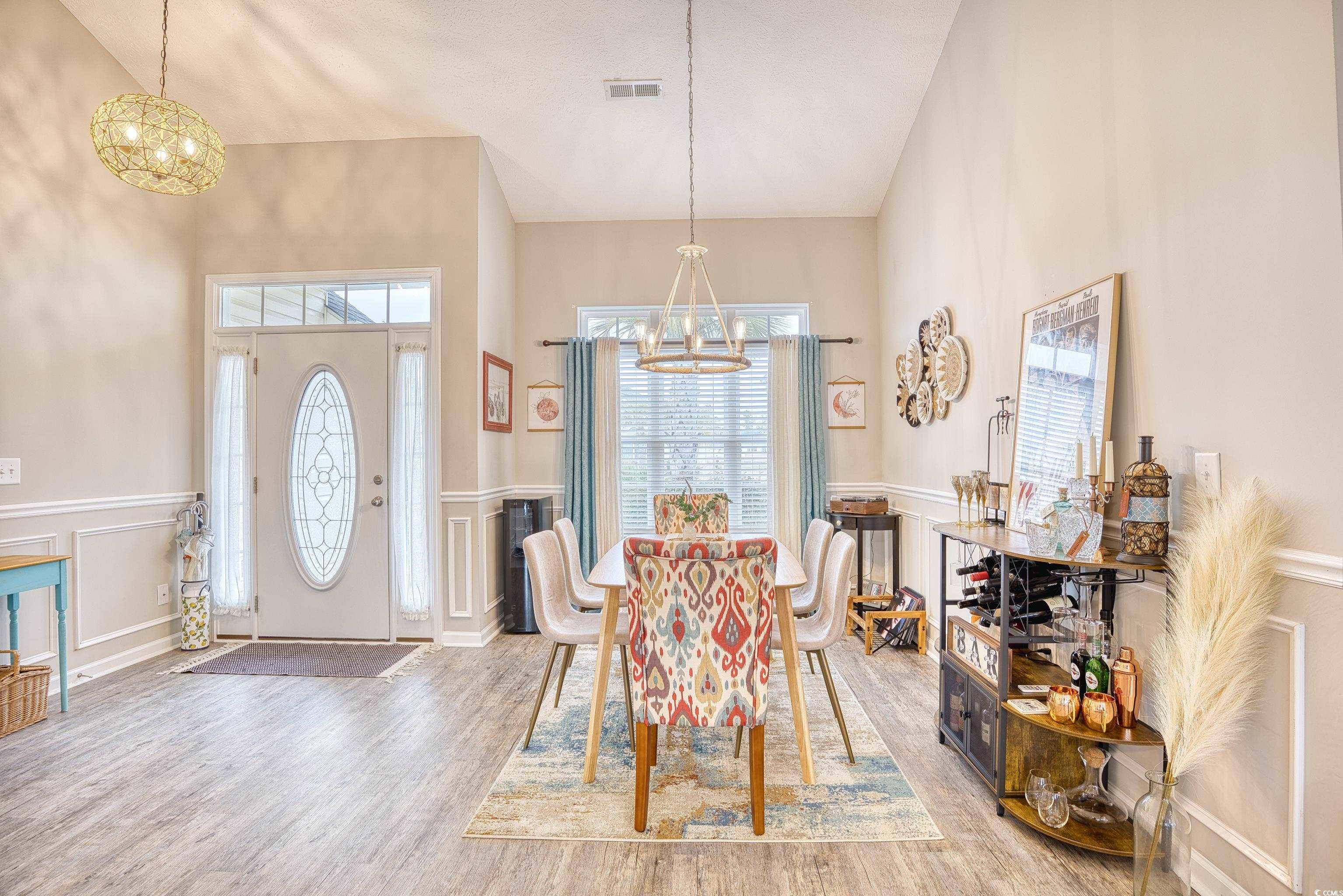 520 Hobie Cat Road Myrtle Beach, SC 29588 - Photo 18 of 40 Dining area with an inviting chandelier, vaulted c
