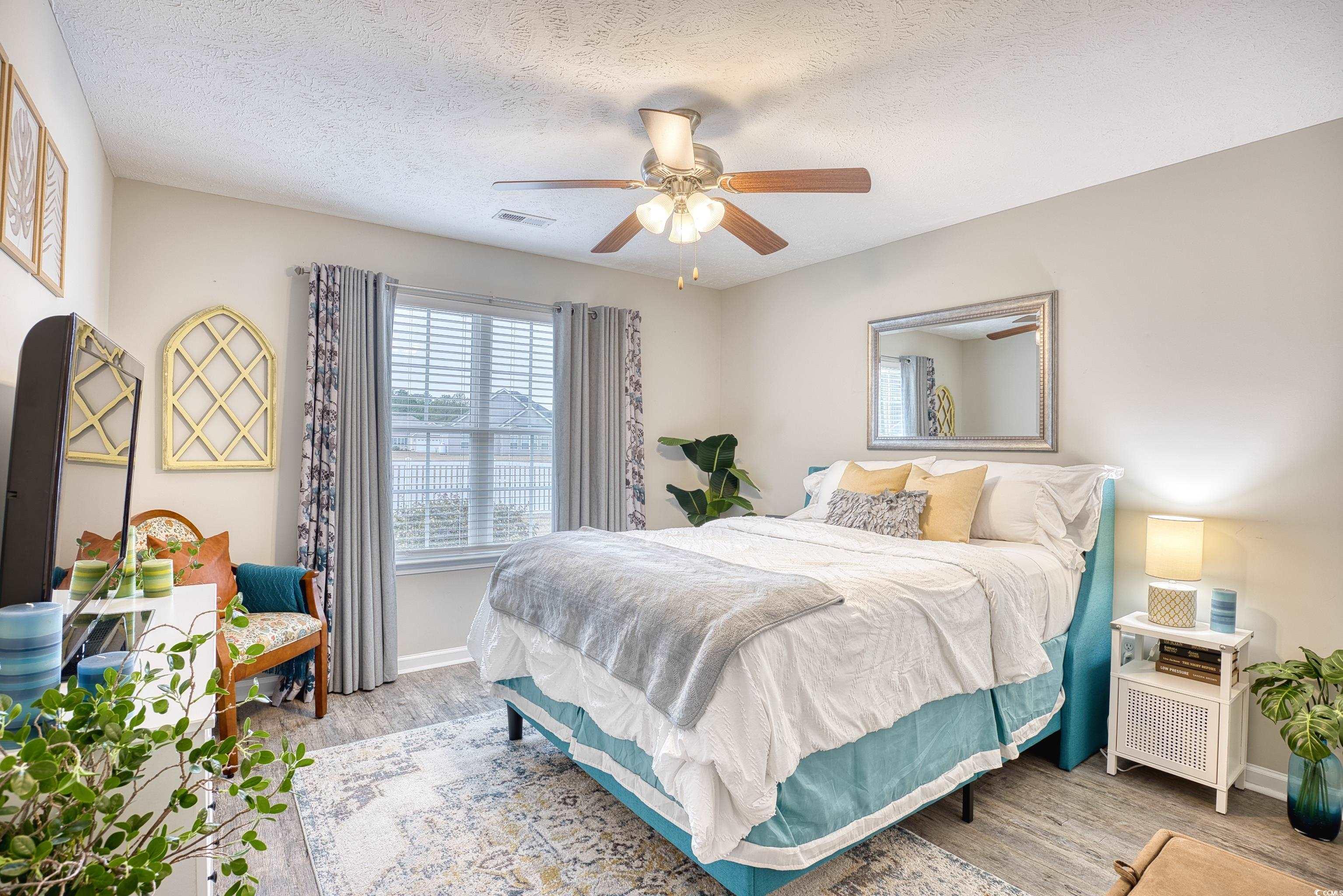 520 Hobie Cat Road Myrtle Beach, SC 29588 - Photo 27 of 40 Bedroom featuring a textured ceiling, ceiling fan,
