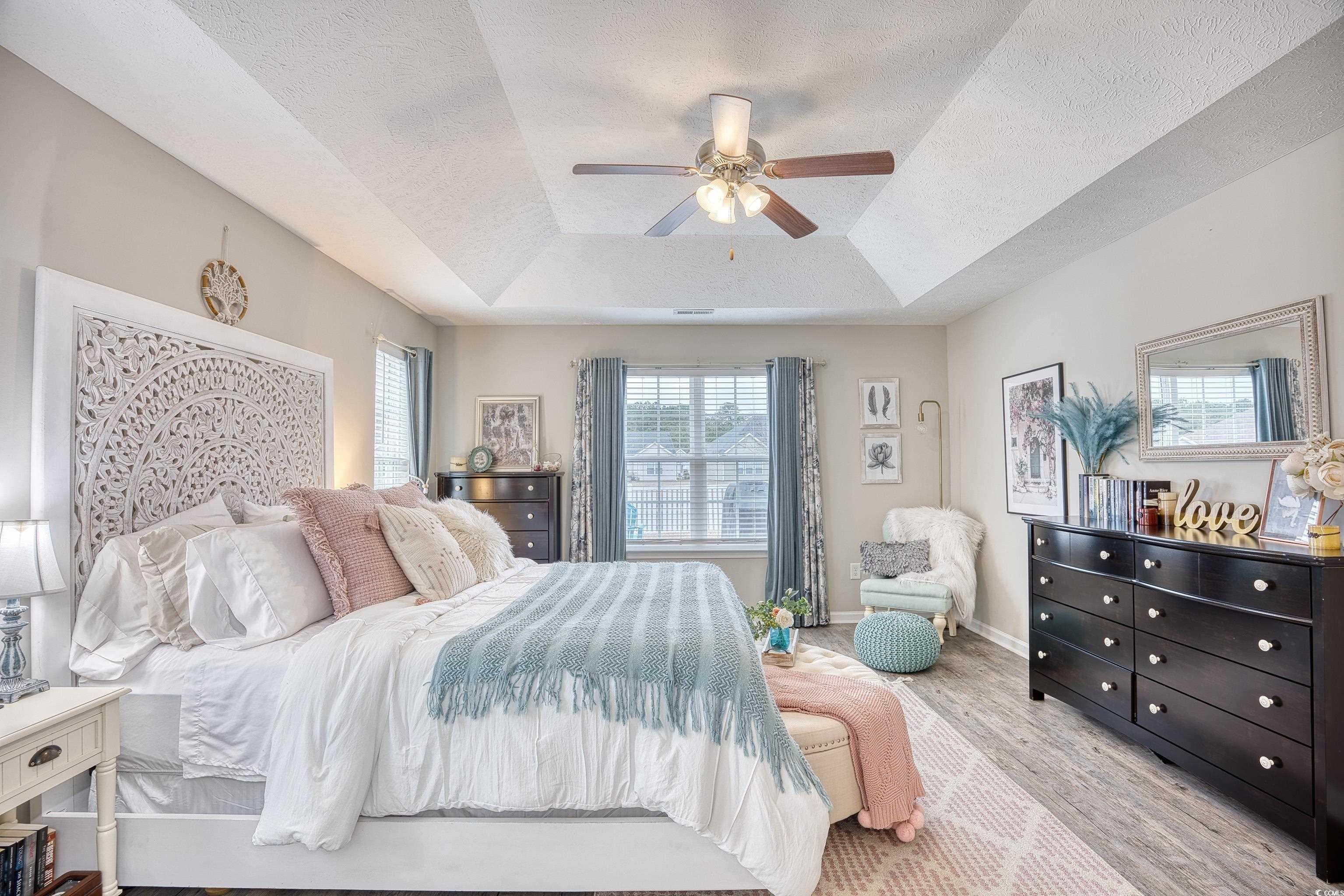 520 Hobie Cat Road Myrtle Beach, SC 29588 - Photo 31 of 40 Bedroom featuring ceiling fan, a tray ceiling, and