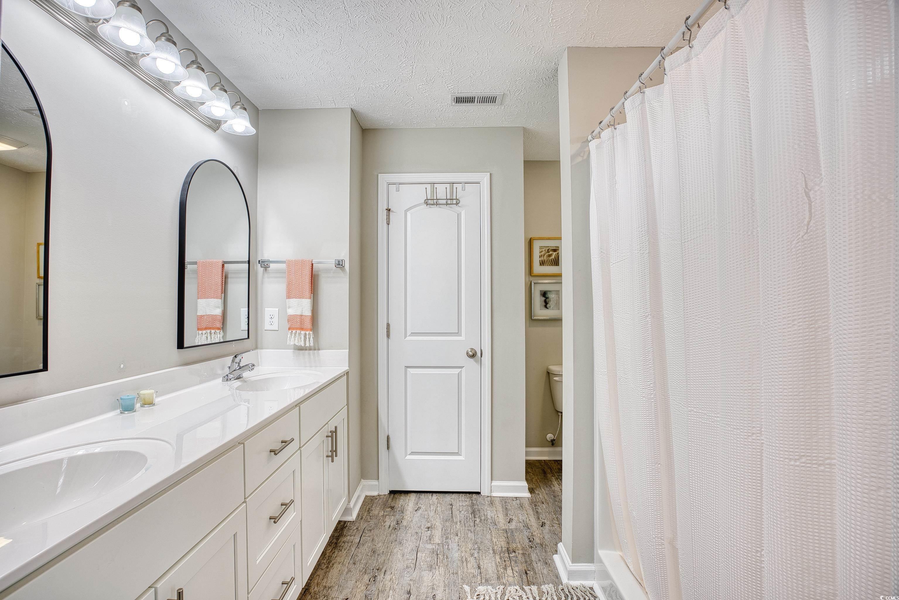 520 Hobie Cat Road Myrtle Beach, SC 29588 - Photo 34 of 40 Bathroom with toilet, a textured ceiling, curtaine