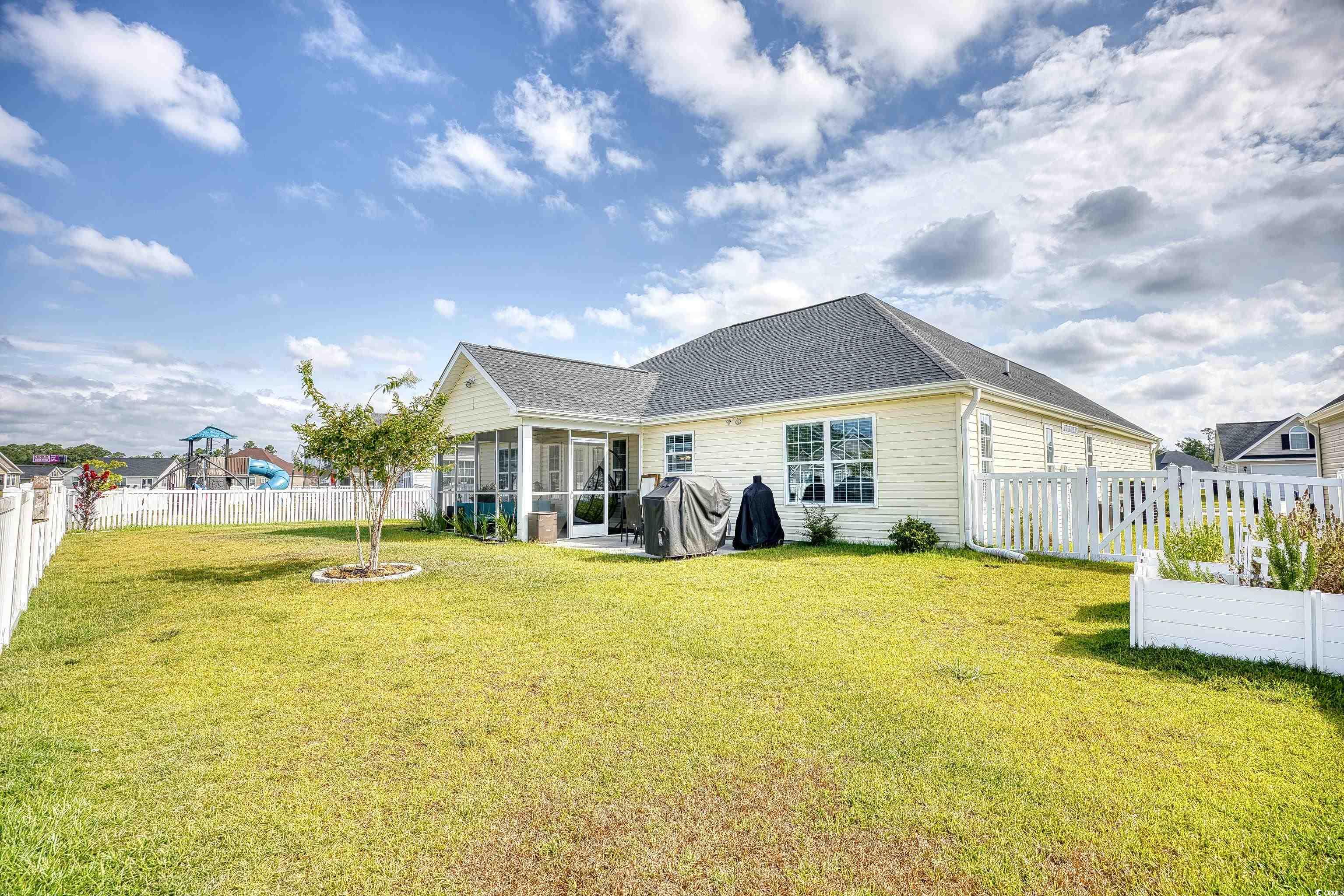 520 Hobie Cat Road Myrtle Beach, SC 29588 - Photo 39 of 40 Back of house with a playground and a yard