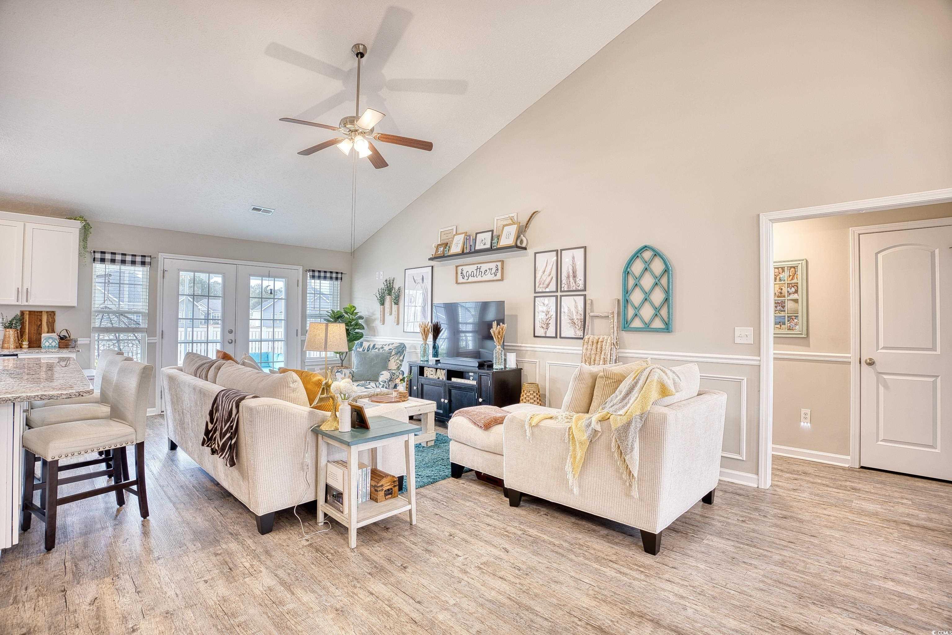 520 Hobie Cat Road Myrtle Beach, SC 29588 - Photo 6 of 40 Living room with high vaulted ceiling, ceiling fan