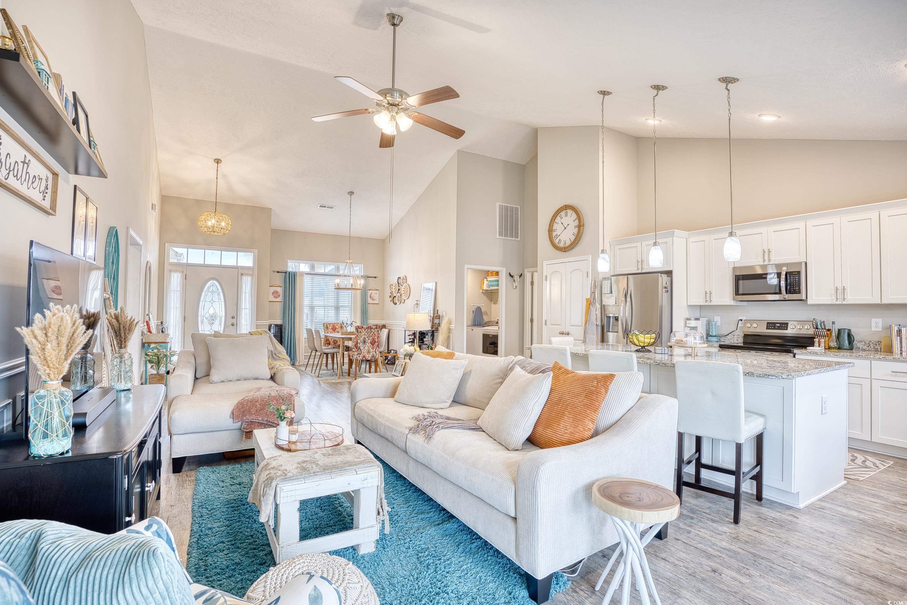 520 Hobie Cat Road Myrtle Beach, SC 29588 - Photo 9 of 40 Living room with ceiling fan with notable chandeli