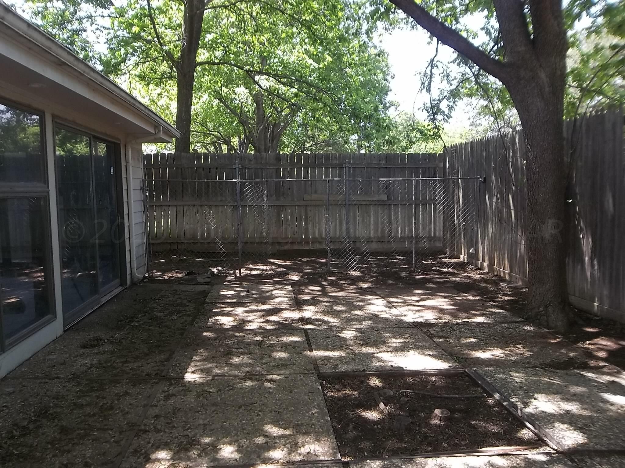 6700 Jameson Road Amarillo, TX 79106 - Photo 6 of 41 a view of a tree in a backyard