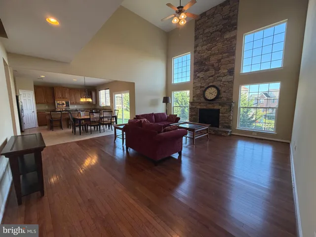 a living room with fireplace furniture and a wooden floor