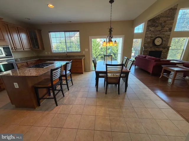 a kitchen with stainless steel appliances granite countertop sink stove top oven and cabinets