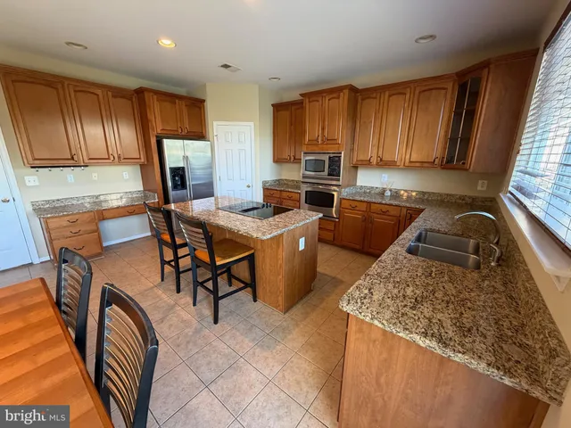 a kitchen with a sink and wooden cabinets