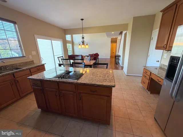 a dining room with furniture wooden floor and a chandelier