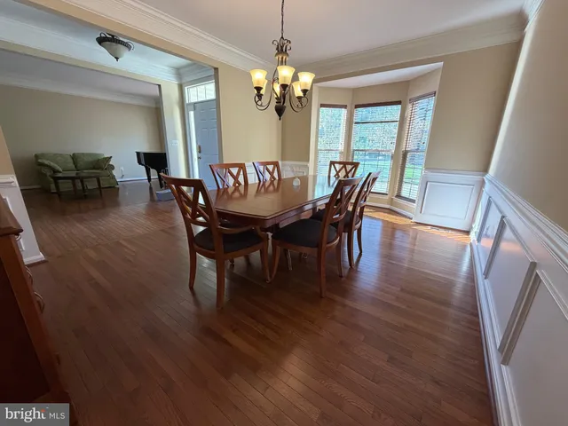 a living room with furniture and a piano