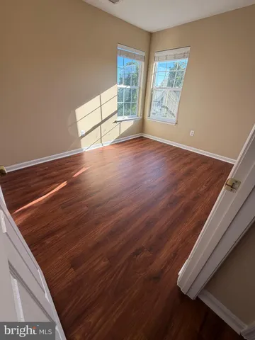 a view of a room with wooden floor