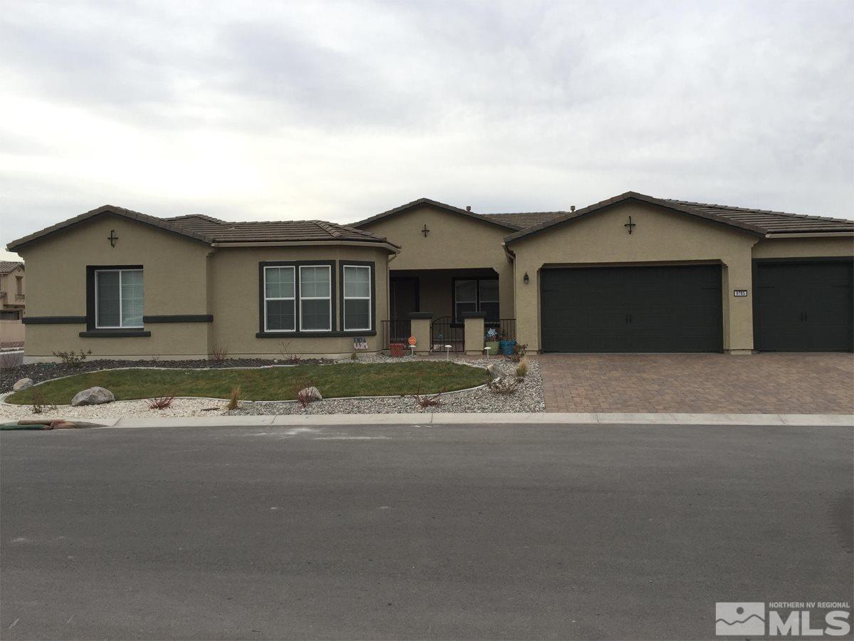 9785 Cardigan Bay Lane Reno, NV 89521 - Photo 1 of 1 a front view of a house with a garden