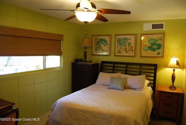 a living room with furniture a flat screen tv and a window