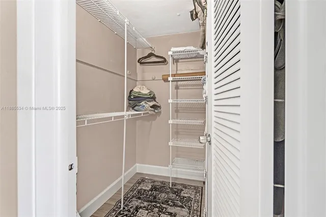 a kitchen with cabinets and wooden floor