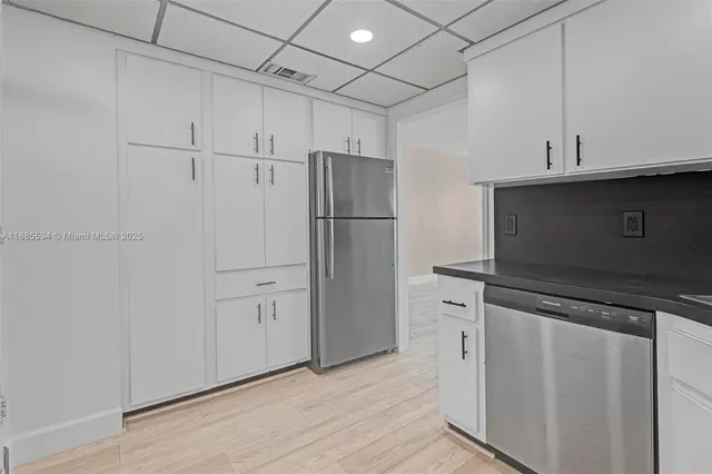 a view of a refrigerator in kitchen