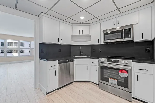 a view of an empty room and wooden floor