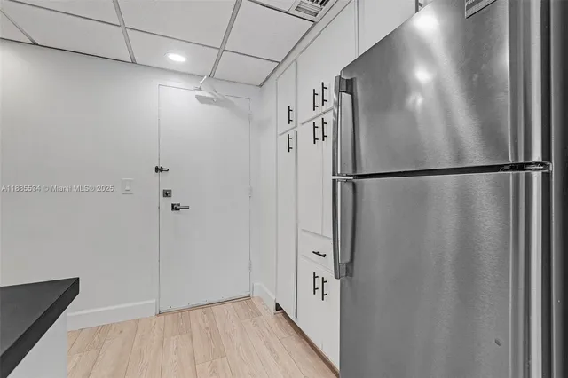 a kitchen with cabinets and stainless steel appliances