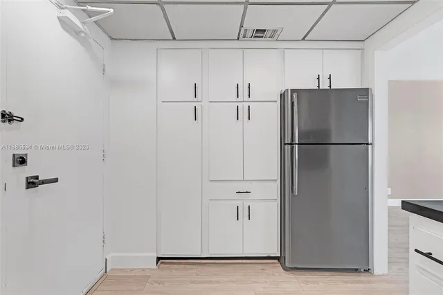 a bathroom with a granite countertop sink a toilet and a mirror