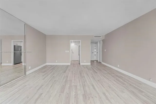 a bedroom with a bed and glass window