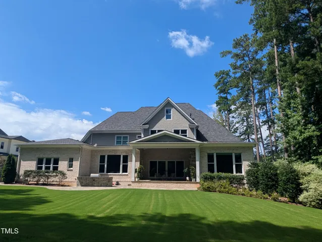 a front view of house with yard outdoor seating and green space