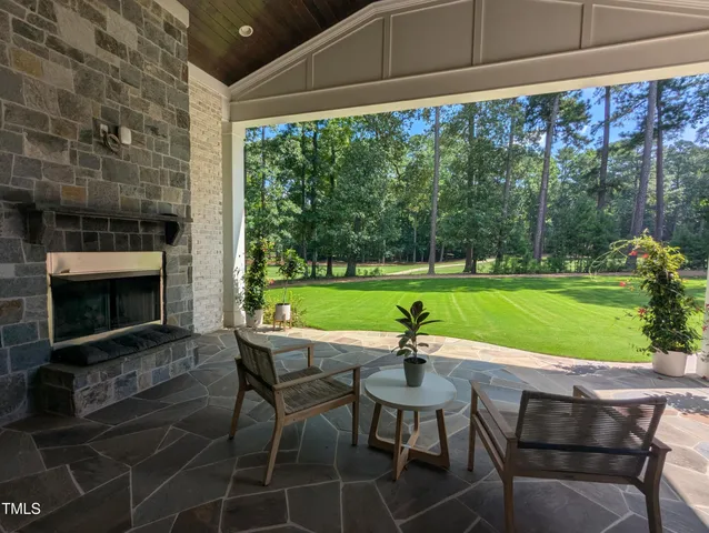 a view of a chairs and table in the patio with a fire pit