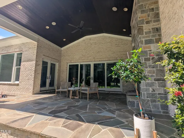 a backyard of a house with outdoor seating