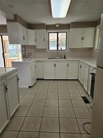 a kitchen with a cabinets and window