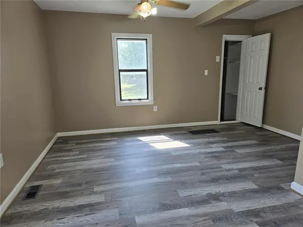 wooden floor in an empty room with a window