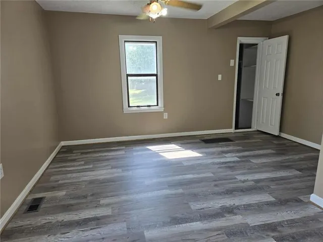 wooden floor in an empty room with a window