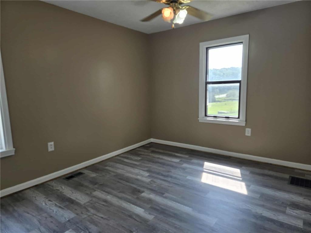 2907 Oneida Valley Road Hilliards, PA 16040 - Photo 16 of 42 an empty room with wooden floor and windows