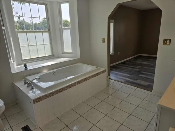 a bath tub sitting next to a window