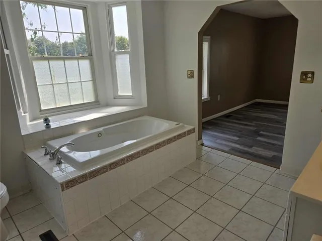 a bath tub sitting next to a window