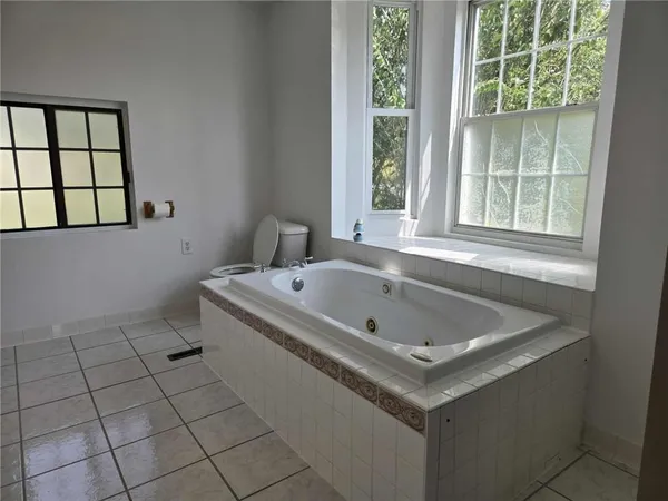 a bathroom with a tub sink and window
