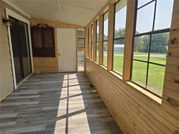 a view of balcony with wooden floor and windows