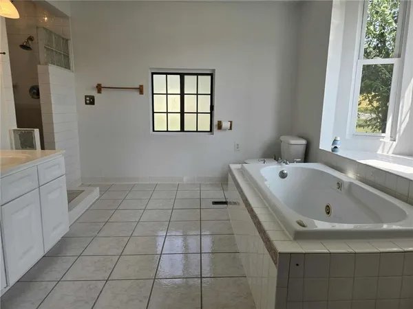 a bathroom with a bathtub sink and window