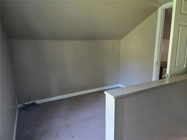 an empty room with a empty space and windows