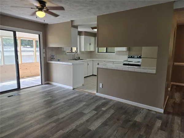 a view of a kitchen with a sink a cabinet and a refrigerator