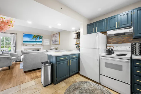 a kitchen with refrigerator cabinets and a sink