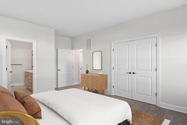 a bedroom with a bed and a dresser