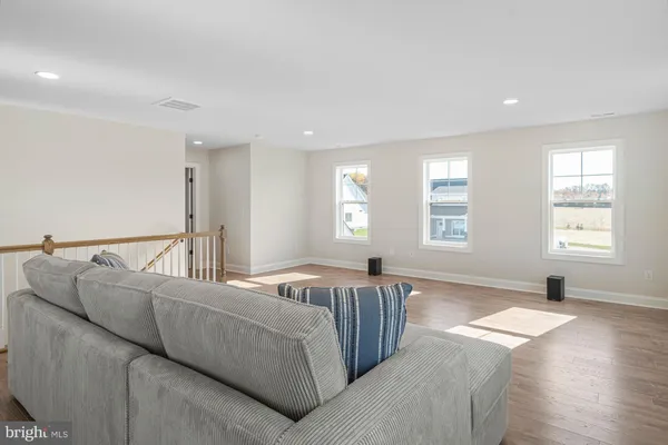 a living room with furniture window and wooden floor