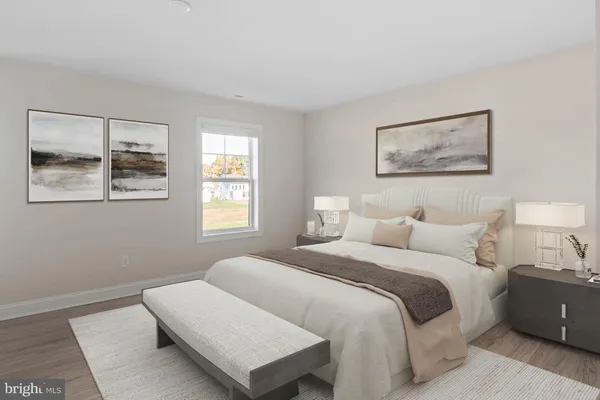 a bedroom with a bed and a lamp on dresser
