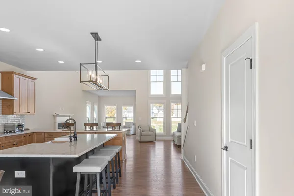 a very nice looking dining room with wooden floor and a chandelier