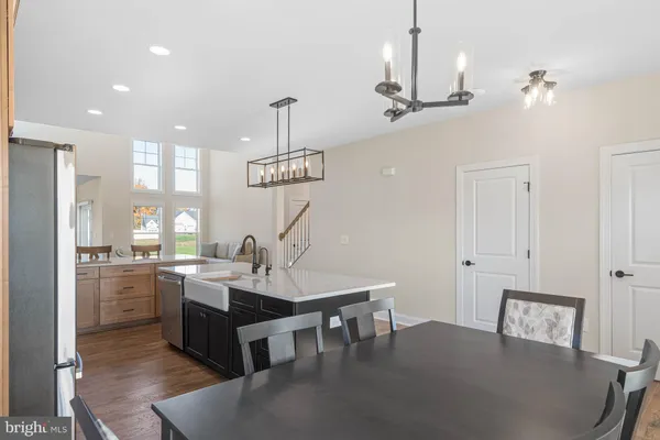 a very nice looking dining room with a table chairs and chandelier