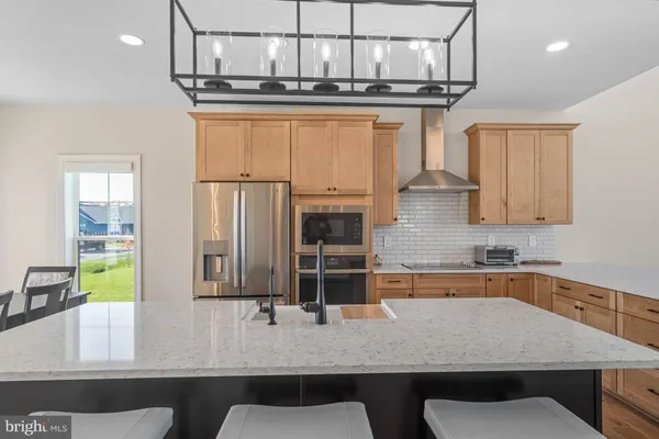 a kitchen with stainless steel appliances granite countertop a stove top oven a sink and dishwasher