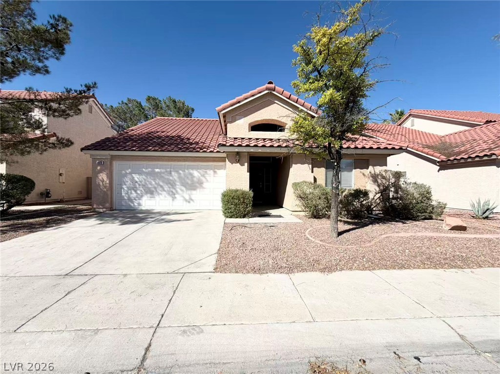8620 Magnolia Ridge Avenue Las Vegas, NV 89134 - Photo 1 of 15 A terracotta-tiled roof crowns this stucco-sided residence, featuring a two-car garage and xeriscaped front yard.
