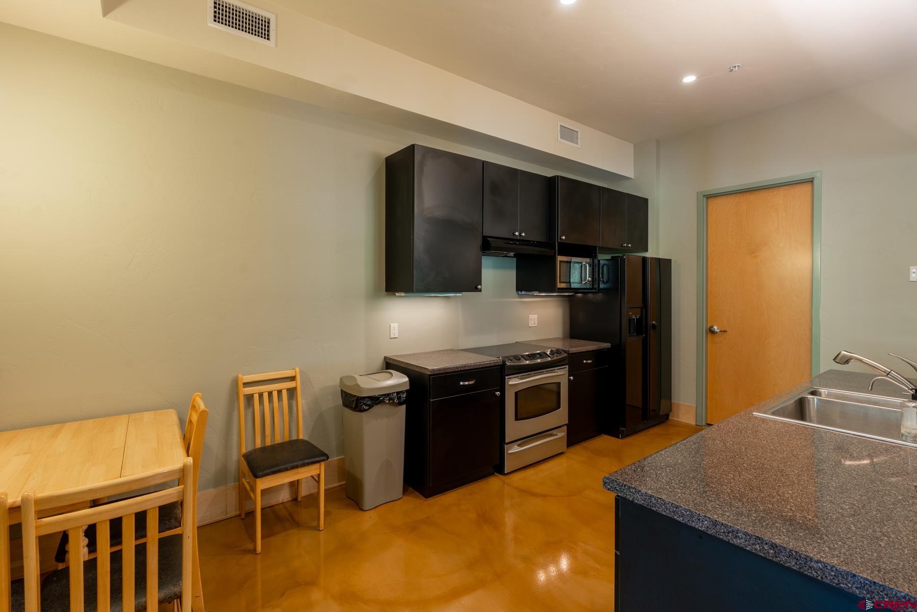 555 Rivergate Lane, Unit B482 Durango, CO 81301 - Photo 27 of 35 a kitchen with stainless steel appliances granite countertop a stove and a refrigerator
