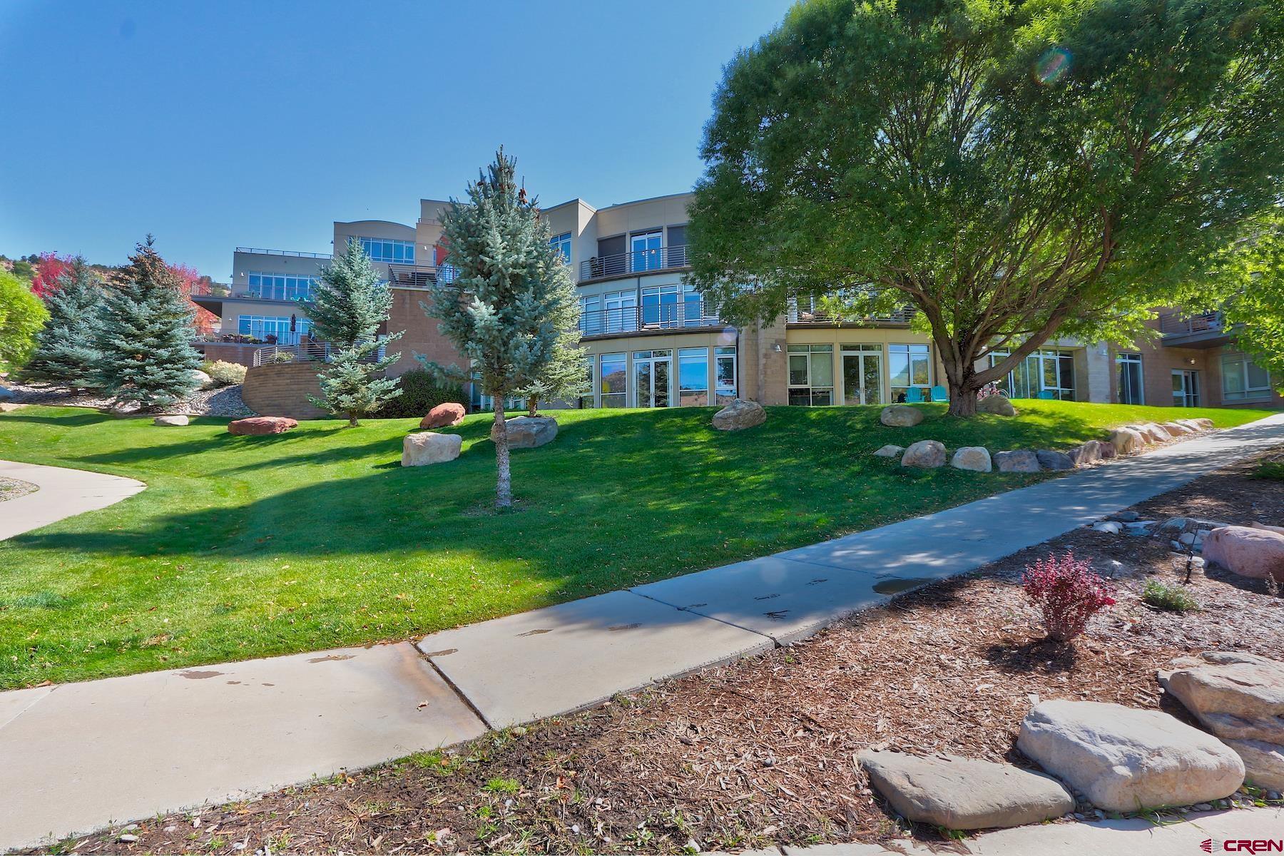 555 Rivergate Lane, Unit B482 Durango, CO 81301 - Photo 10 of 35 a front view of a house with a yard and garage