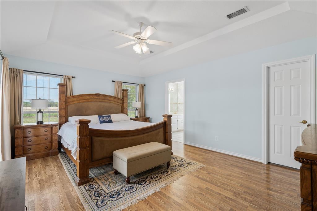 271 VZ County Road Canton, TX 75103 - Photo 21 of 40 a bedroom with a bed and a chandelier