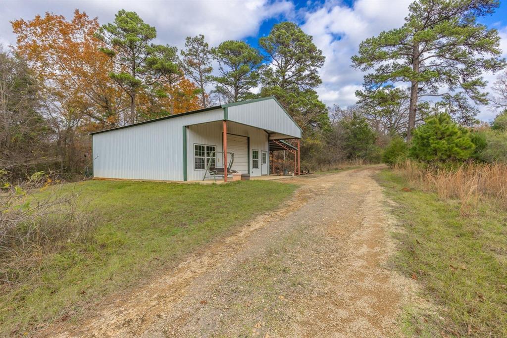 648 County Road 2337 Pittsburg, TX 75686 - Photo 16 of 21 a house with trees in the background
