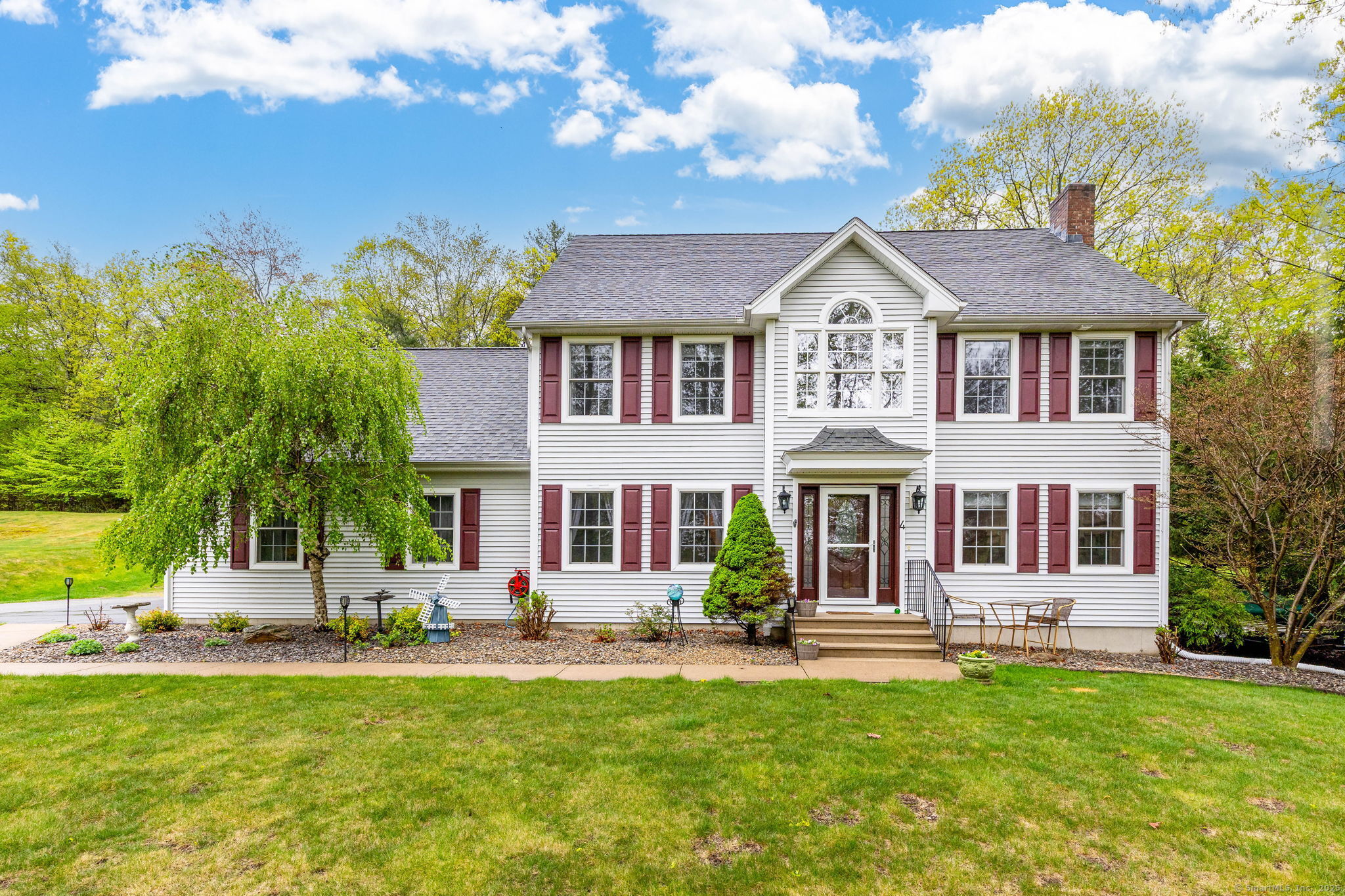 4 Hemlock Trail Ellington, CT 06029 - Photo 1 of 1 a front view of a house with a garden